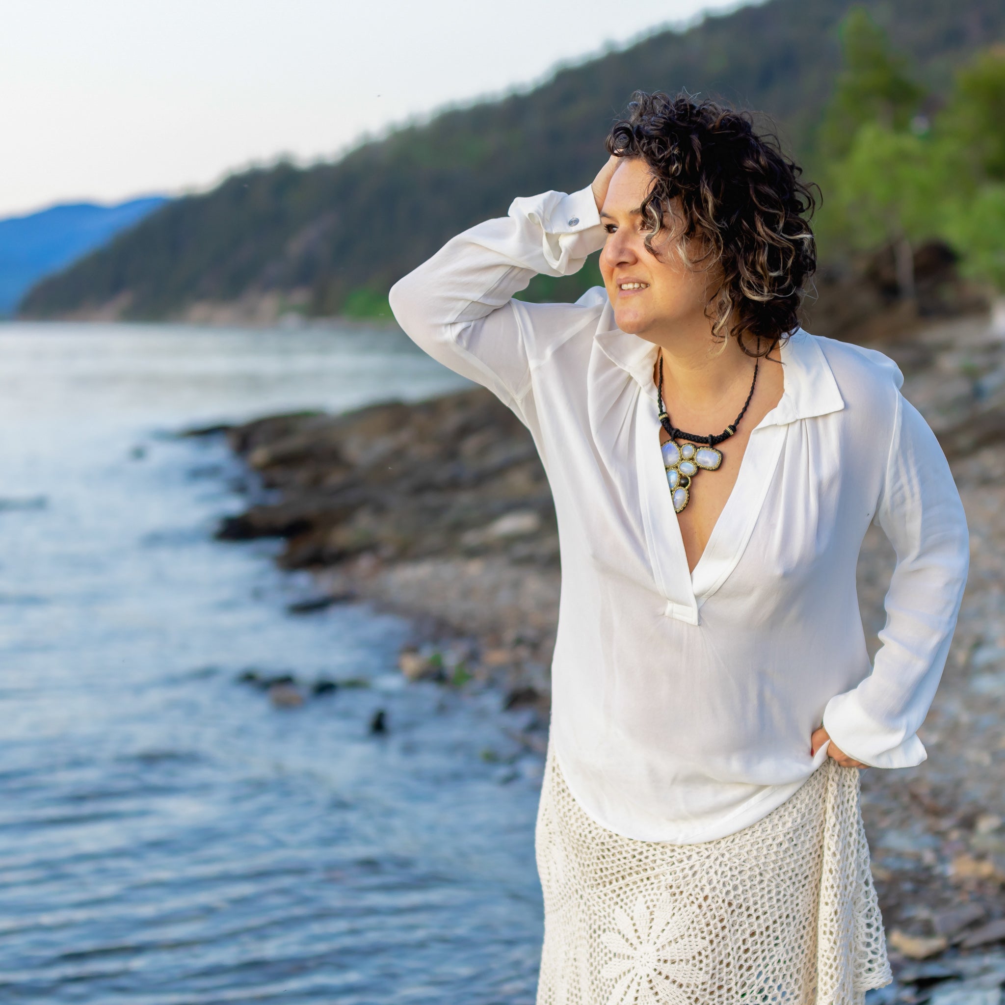 model in white with necklace with rainbow moonstones